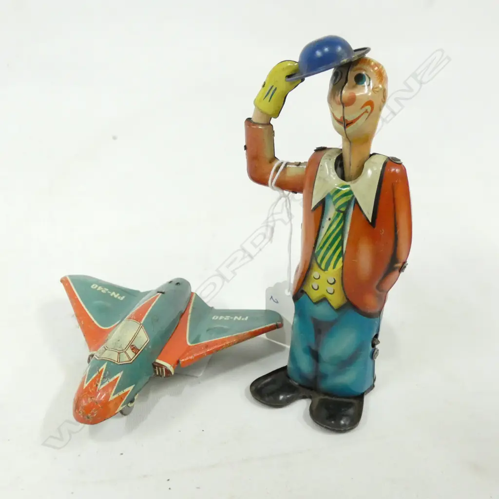 2 OLD TIN PLATE TOYS; MAN DOFFING HAT H..150 (KEY MISSING) & FIGHTER JET L. 110MM Image 1++